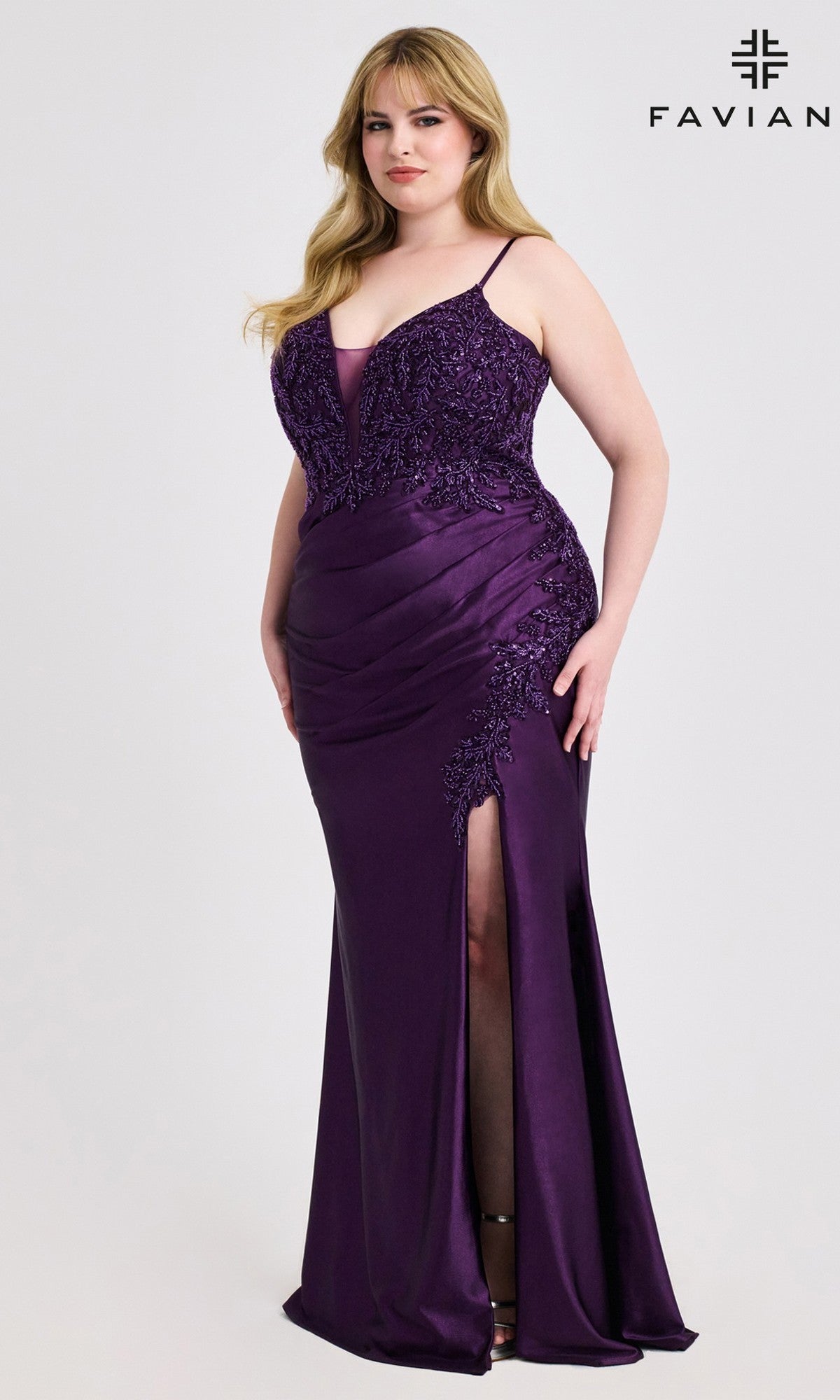 A woman models the Faviana 9608 Plus-Size Beaded-Bodice Prom Gown in Purple Amethyst—floor-length, sleeveless, with a beaded bodice and side slit—standing before a plain white background.